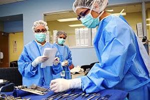 Surgical Tech students working together in scrubs